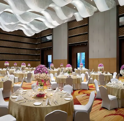 Banquet tables set for dinner in the JW Marriott Bengaluru ballroom